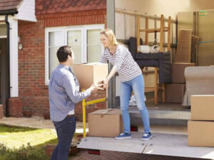 A couple moving house with a removal lorry